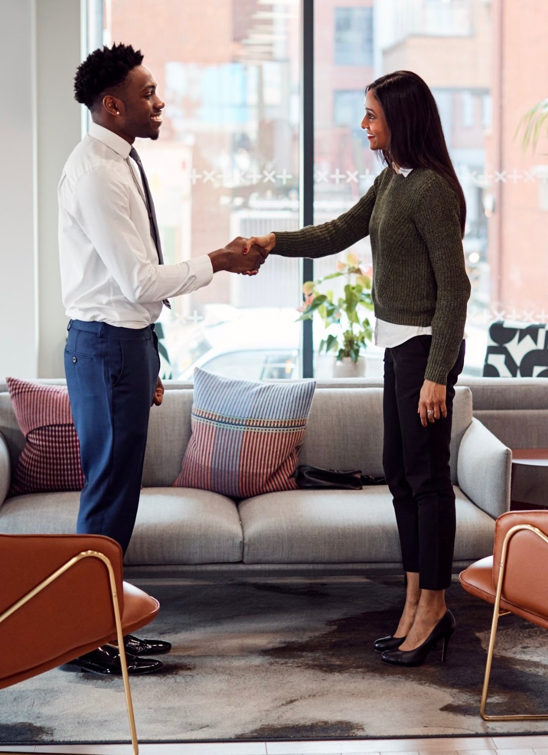 young-man-young-woman-interview-shaking-hands young-man-young-woman-interview-shaking-hands
